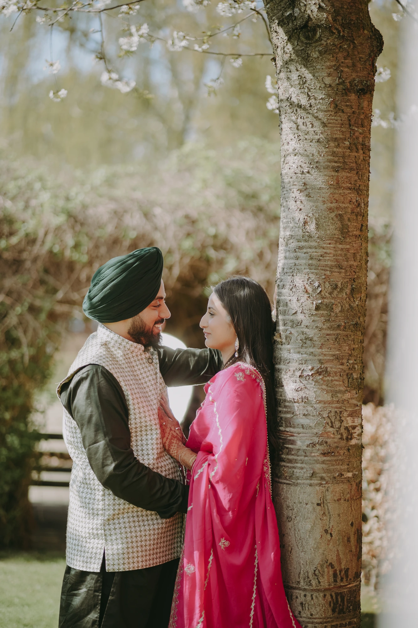 Couple standing together by a blossoming tree