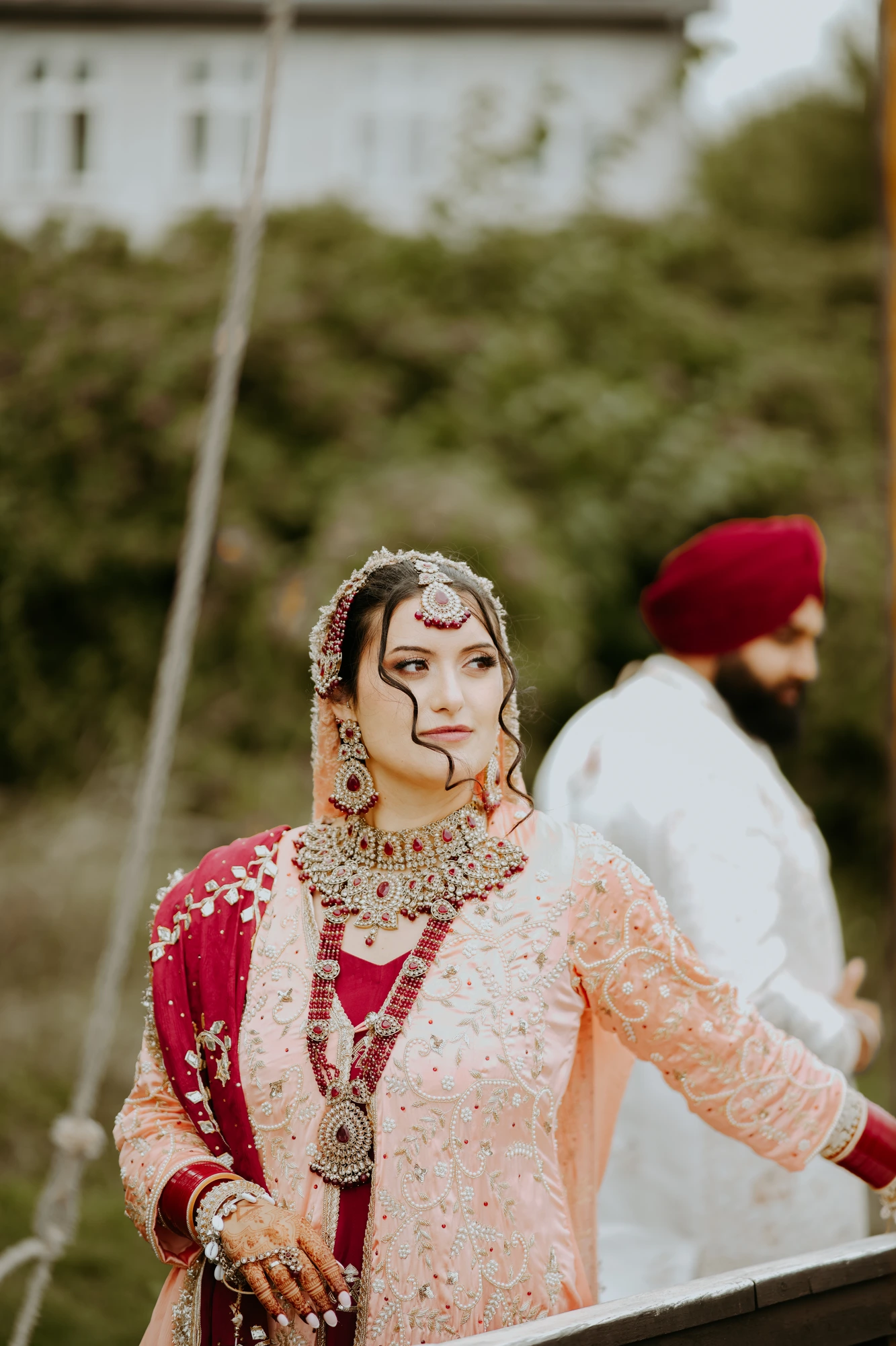 Bride in embroidered red and blush attire