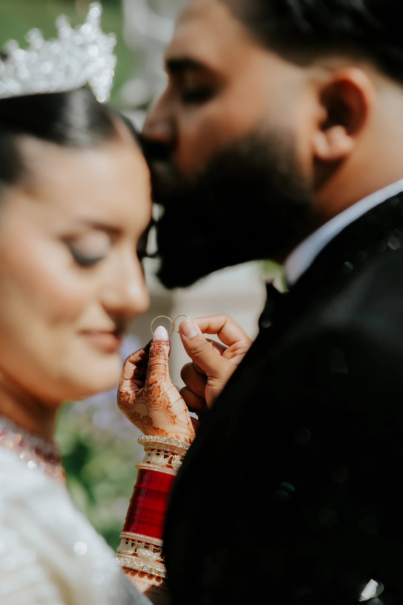 Couple holding two wedding rings between them
